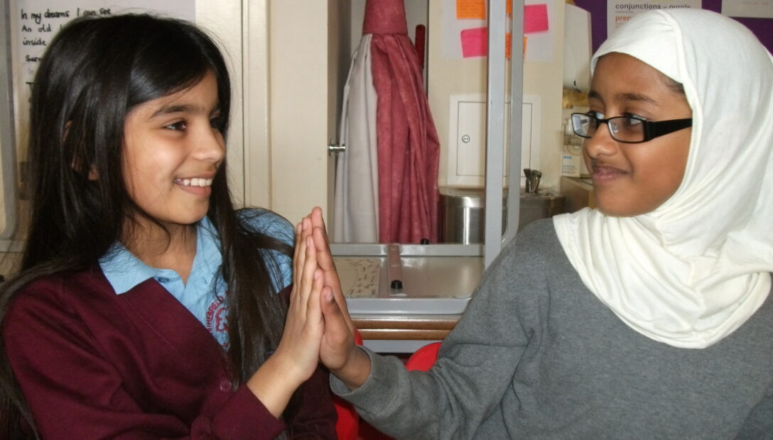 Two primary school child high-fiving