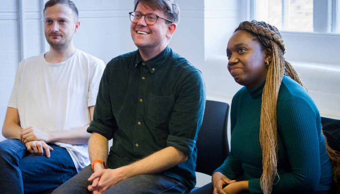 Three workshop participants listening