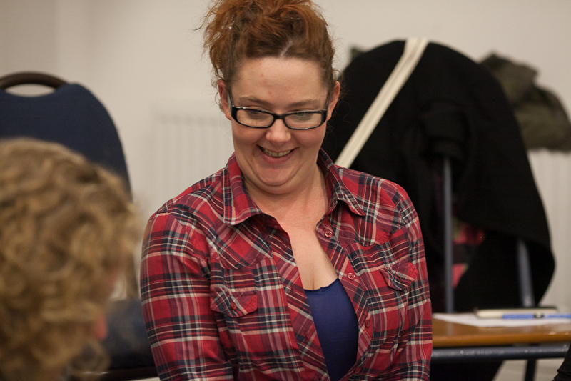 A woman smiling at a workshop
